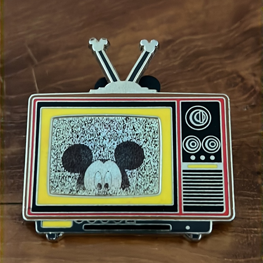 Walt Disney World pin traders, holographic TV set, three images of Mickey Mouse.